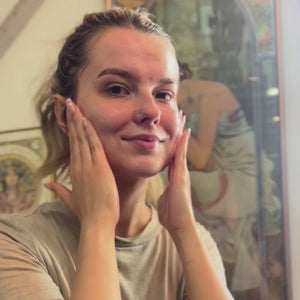 woman applying daily facial moisturizer with whole plant extracts
