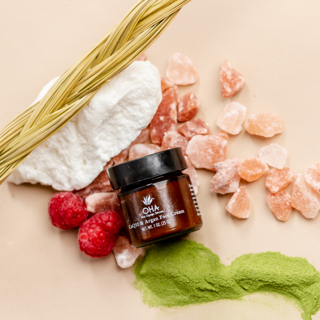 Organic antioxidant face cream surrounded by raspberries and green tea powder