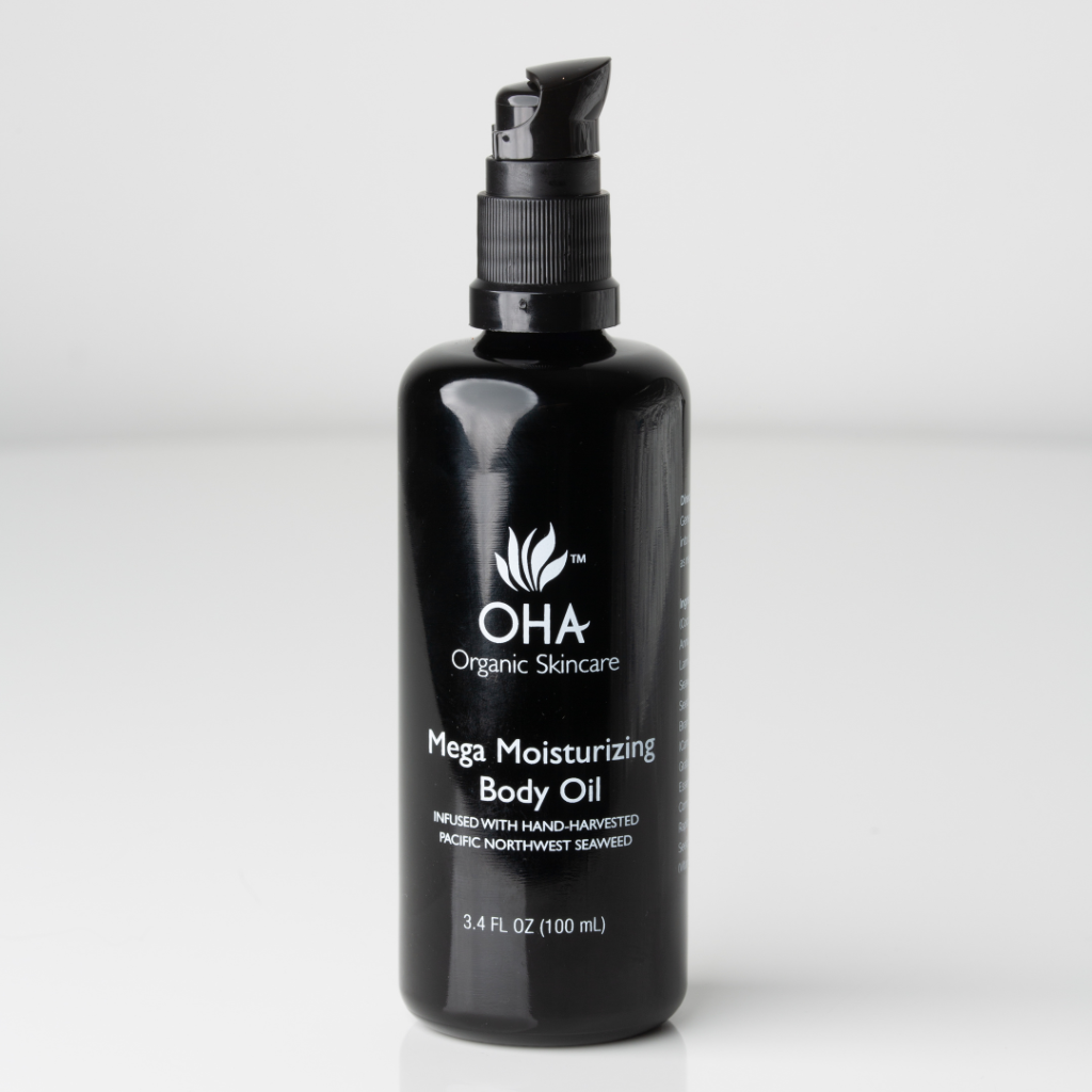 Organic hydrating body oil in a glass bottle.