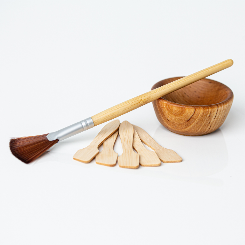 Eco-friendly skincare mixing set with wooden bowl, fan brush, and applicator