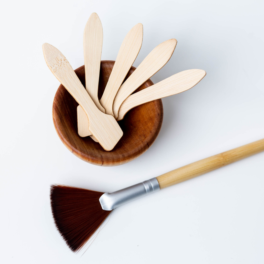 Eco-friendly skincare mixing set with wooden bowl, fan brush, and applicator