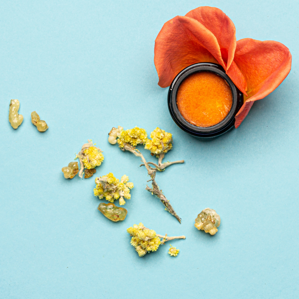 Orange hydrating facial balm in black jar