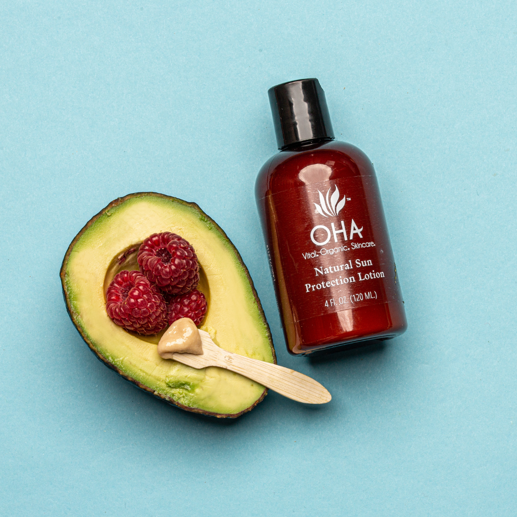 Bottle of environmentally friendly sun protection lotion with avocado and raspberries