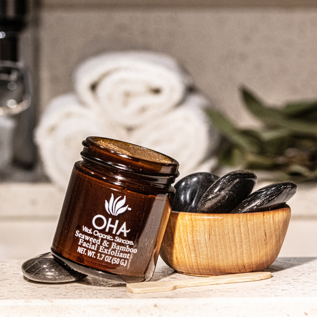 Opened jar of gentle exfoliant made with seaweed and bamboo shown on bathroom sink